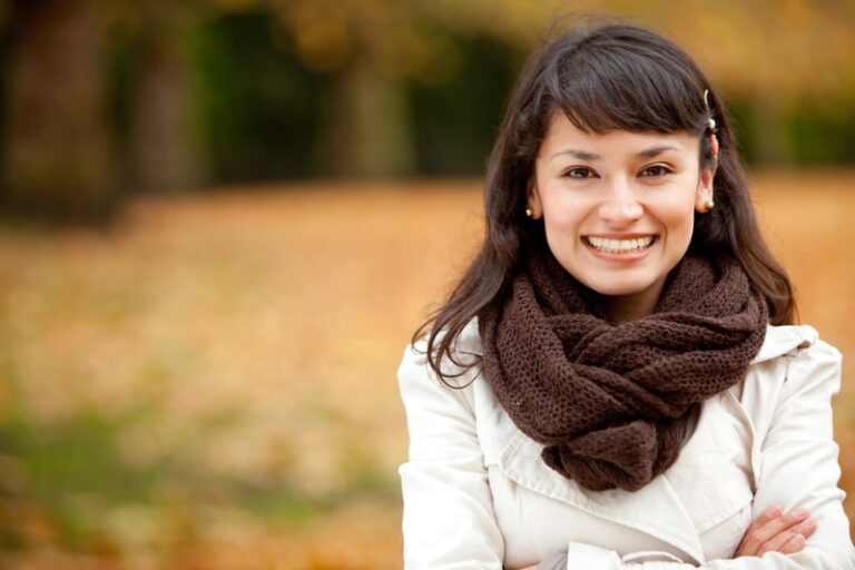 Autumn woman portrait smiling outdoors at the park